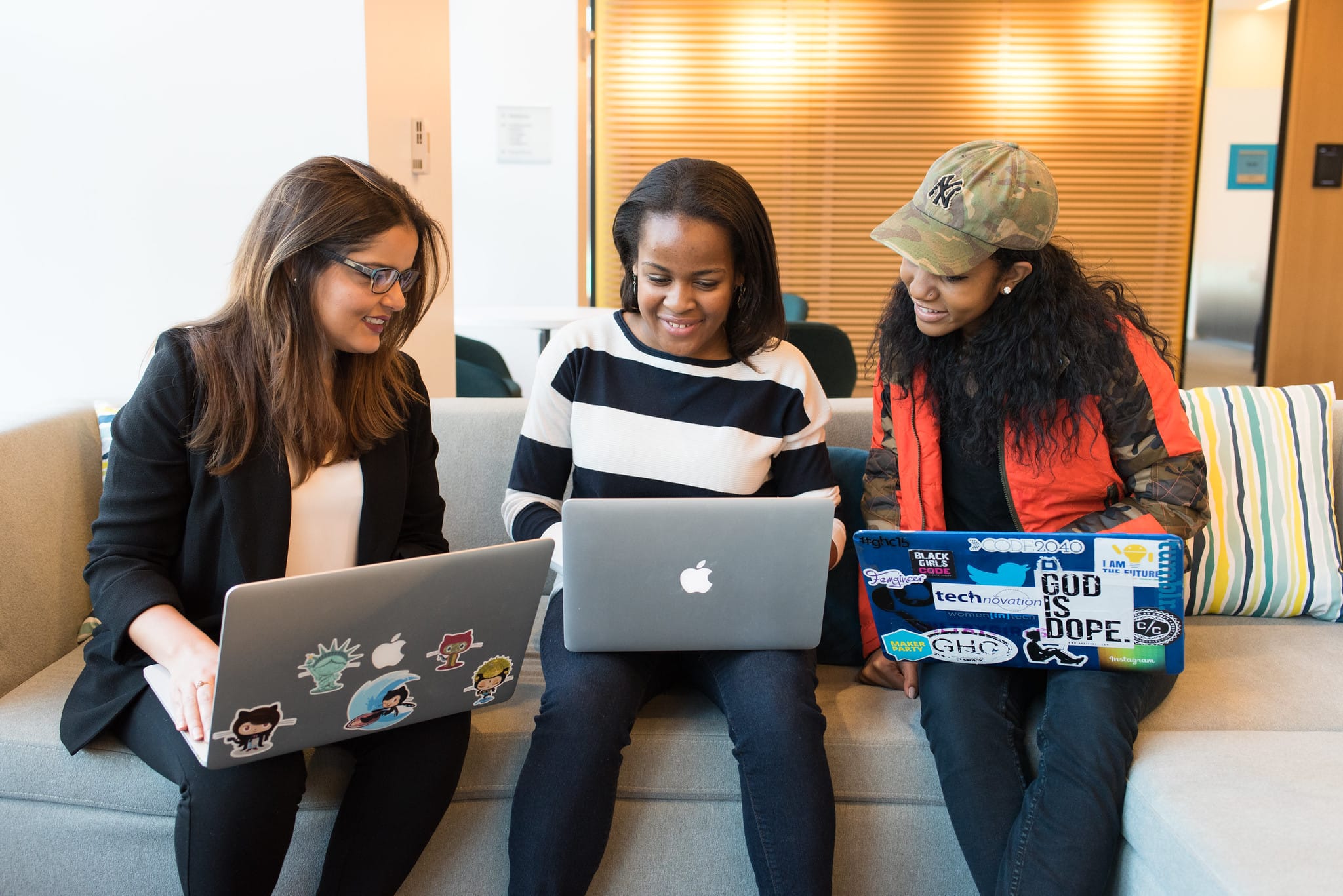 Group of women looking at a laptop